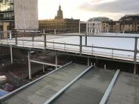 View over the partly completed staff accommodation building at the east side of the station. Work on this has been suspended pending a decision involving a revised proposal for an extension to Buchanan Galleries. This may involve the demolition of the partly completed new staff building. Meanwhile, station staff are using temporary cabins alongside platform 7<br>
[see image 61069]  <br><br>[Colin McDonald 25/01/2018]