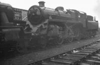 Standing in the yard at Bathgate in February 1966 is BR Standard class 4 2-6-0 76105. The locomotive had been withdrawn from Polmadie during January that year and by the end of April would be cut up in the yard of Motherwell Machinery & Scrap, Wishaw. Built at Doncaster in July 1957, the locomotive had an operational life of just eight and a half years. <br><br>[K A Gray 05/02/1966]