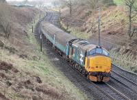 37402 propels 2C32 Carlisle to Preston under Cleveley Bank Lane bridge at Forton on 1st February 2018. Although loco hauled trains will continue on the Cumbrian Coast after the May 2018 timetable change it seems this weekday jaunt from Barrow to Preston and back will unfortunately cease.<br><br>[Mark Bartlett 01/02/2018]