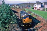On Good Friday 24th March 1989, loco 26 051 is seen leaving the former station site at Menstrie. It had just delivered loaded molasses tanks to the nearby Glenochil Yeast Factory. Stirling Castle and the Wallace Monument can be glimpsed on the horizon.<br><br>[Mark Dufton 24/03/1989]