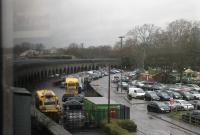 Grab shot from a Class 165 DMU showing part of the viaduct on the GWR Windsor branch in January 2018. The branch is only two miles long and over a mile of that is on this low brick structure. The two yellow vehicles in the yard are ex-military DUKW amphibious trucks, now used for tourist trips around Windsor on the roads and the Thames.<br><br>[Mark Bartlett 27/01/2018]