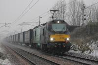 First snow of the winter in the Garstang area on 6th February 2018. DRS electro-diesel 88006 <I>Juno</I> heads north with an early running Daventry to Mossend <I>Tesco</I>.<br><br>[Mark Bartlett 06/02/2018]
