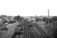 Class A4 60004 'William Whitelaw' on southbound train in 1959 at Portlethen. The present station was built slightly further south, occupying the site of the sidings on either side in this view. The footbridge of the new station is on roughly the same site as the old one. [Ref query 6 February 2018]<br><br>[David Murray-Smith 11/08/1959]