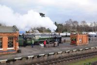 9F 2-10-0 92214 takes a non-stop freight through Quorn & Woodhouse station on 26th January 2018. Note the rake of <I>Windcutter</I> 16T mineral wagons stabled in the yard. <br>
<br>
<br><br>[Peter Todd 26/01/2018]