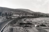 An EMU leaving Largs for Glasgow in Spring 1988  andpassing the Marina. The scene is much changed today - a hard-standing occupies the area to the right and it is usually full of yachts and other craft.<br>
<br><br>[Colin Miller //1988]