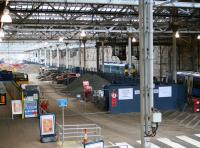 No signs of activity in or around the platform 5 & 6 works compound at Waverley, seen looking east from the cross-station walkway on the morning of 8 February 2018. Just visible on the right is the rear of the 1030 to Glasgow Queen Street at platform 11, while the sleeper locomotive stabled alongside the south wall is 92018.<br><br>[John Furnevel 08/02/2018]