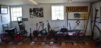 Interior of the railway museum showing draisines: from the left is a motorised example, in the centre a 3-wheel railcycle and on the right is a handcar. Various track tools are shown interspersed with them and there are railway signs and photographs on the walls: Österport was the name of a halt just outside the Visby city walls at the eastern gate.<br><br>[Charlie Niven 05/07/2017]