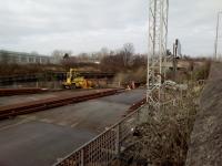 The Voestalpine VAE works was fomerly known as Baileyfield S&C (switch and<br>
crossing) and is still making points and the like as it has been doing for<br>
over 100 years. Ironically, it is no longer rail-served although there is<br>
still a vegetation choked physical connection with the rusting Leith South<br>
branch. The gates in the middle distance show where the siding entered<br>
with the branch beyond it. Looking towards Leith on 8th February 2018.<br>
<br>
<br><br>[David Panton 08/02/2018]