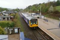 A Sheffield to Manchester service calls at Chinley on a wet 12 May 2013. The single, wide island platform is a significant reduction on what was once a large country station. [See image 32068] for a view in the other direction from a little further west some 45 years earlier.<br><br>[John McIntyre 12/05/2013]