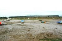 Looking east towards the River Exe estuary at Cockwood Harbour at low tide in the summer of 2002. The train is a First Great Western service from Penzance to Paddington and will shortly pass through Starcross station, some 9 miles short of its next scheduled stop at Exeter St Davids. <br><br>[Ian Dinmore 29/06/2002]