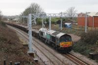 Freightliner 66413, still in its former DRS livery, stands on the Up Line outside Poulton with an infrastructure train, one of several lined up on this stretch that day - 10th February 2018.<br><br>[Mark Bartlett 10/02/2018]