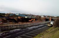 Meadows signal box was between the two pairs of lines which pass under<br>
Seafield Road. It was in the middle of this picture, taken on 12th February 2018.<br>
<br>
Looking west. The moribund South Leith (or Leith South) branch lies between<br>
the fence and the digger engaged in intriguing groundwork. These are<br>
Network Rail vans on the right. I wonder what is going on; is the branch<br>
being measured up for a coffin, perhaps? For a yesteryear photo, see:<br>
<br>
https://ic.pics.livejournal.com/rock_dinosaur/77029914/864393/864393_1000.jpg<br>
<br>
<br><br>[David Panton 12/02/2018]