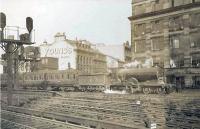 Looking north across the approach lines outside St Enoch station on the last day of September 1948. Ex-Caledonian 4-4-0 14508 (later 54508) is reversing stock into platform 1.    <br><br>[G H Robin collection by courtesy of the Mitchell Library, Glasgow 30/09/1948]