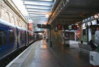 The Waverley 'sub' platforms looking east towards the cross-station walkway on 8 February 2018, with the 1023 to Helensburgh Central awaiting departure time <br>
 at platform 8. The passenger at platform 9 is an early arrival for the 1052 VT  service to Euston (scheduled to work in at 1017 as the 0616 from Birmingham New Street.). Although still limited in the amount of natural light received, due to being 'hemmed in' on all sides, this end of the sub platforms benefitted considerably from the new canopies and lighting installed in 2014 [see image 12512]. <br><br>[John Furnevel 08/02/2018]