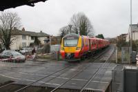 707026 rumbles over the level crossing as it leaves Egham on a Waterloo to Weybridge service on 27th January 2018. Egham has a very frequent service of trains but beyond the next stop at Virginia Water the Chertsey and Weybridge line diverges from the other electrified line to Reading.<br><br>[Mark Bartlett 27/01/2018]