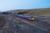 Evening train southbound at Falahill. There were loops on either side and two sidings to the left until closure of the box in 1963. The railway cottage was demolished in the run up to the re-opening.<br><br>[Ewan Crawford 24/02/2018]