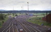 Looking towards the Down arrivals yard ('Millerhill Yard Carlisle Arrival Sidings') at Millerhill in the 1980s, with the lifted Waverley Route on the left and Bilston Glen branch on the right.<br>
<br>
<br><br>[Bill Roberton //1985]