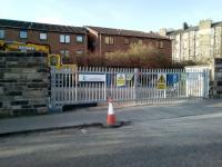 Street ent​​rance to the trackwork compound on the site of Abbeyhill station. The sign on the left is of historical interest, and there are several like it still up at Waverley. I'm guessing that whoever was responsible for signs got his P45 before he could take any down ...<br><br>[David Panton 24/02/2018]