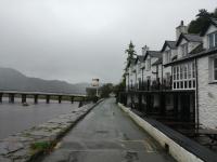 Friday the 13th, lunchtime, a miserable wet and cold day and unfortunately no time to stop at the hotel for a warm up. Penmaenpool is a hamlet on the south side of estuary of the River Mawddach in Wales, near Dolgellau. The former trackbed through the site is now in use as a footpath, the Llwybr Mawddach or Mawddach Trail. This view looks towards the old station site with the toll bridge on the left.<br>
<br><br>[Alan Cormack 13/10/2017]