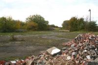 Part of the large concourse at the former Filey Holiday Camp station on 11 October 2009, looking towards the buffer stops on platforms 3 & 4. The ruins of the single storey concrete building that once stood here occupy the foreground. The tunnel under the A165 giving access to the camp itself is off to the right. [See image 26824] [Ref query 5 March 2018] <br><br>[John Furnevel 11/10/2009]