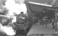 Black 5 45444 takes on water at Carlisle platform 3 with a summer Saturday Blackpool - Glasgow train on 30 July 1966. The carriage board on the train alongside at platform 4 reads 'Birmingham - Edinburgh'. <br><br>[K A Gray 30/07/1966]