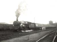 A Sunday relief to the up <I>Thames-Clyde Express</I> runs past Dumfries South goods yard shortly after leaving the station on 15 July 1956. Locomotive in charge is Corkerhill Jubilee 45711 <I>Courageous</I>. [Ref query 7 March 2018]<br><br>[G H Robin collection by courtesy of the Mitchell Library, Glasgow 15/07/1956]