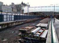 Construction by numbers. The Platforms 5 and 6 extension work is not as easily visible at it was with Platform 12, but a walk to the end of Platform 4 reveals that construction is proceeding despite the hiatus caused by the Carillion collapse. Tracks are temporarily removed, edging is being reconstructed and it looks as though excavation is under was at the western end. Completion is scheduled for July. Photographed on 7 March.<br><br>[David Panton 07/03/2018]