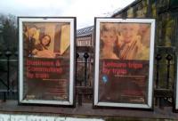 It used to be common to see advertising posters at railway sites other than open stations, but this is dying out if not already dead. These First ScotRail posters at Newington are 10 or 11 years old. The sepia effect is caused by the ageing plastic covering. I leave it to you to decide whether you find these people appealing (and no, that doesn't appear to be Esther Rantzen).<br><br>[David Panton 24/01/2018]