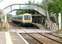 A Great Yarmouth - Norwich train arrives at Brundall in the summer of 2002.<br><br>[Ian Dinmore 19/07/2002]