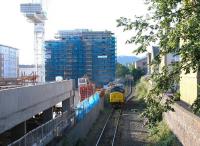 A class 37 stands on the Powderhall branch on a July morning in 2005. The locomotive has recently arrived from Millerhill and is awaiting completion of loading operations before picking up the daily 'Binliner' for Oxwellmains.  <br><br>[John Furnevel /07/2005]