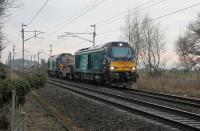 The new Class 88 electro-diesels have been used occasionally on the Heysham and Hartlepool flask trains recently but on 6th March 2018 it was 68023 and 68002 in charge. This is the return Heysham to Sellafield working approaching Bolton-le-Sands level crossing, with a storm damaged tree encroaching on the scene. <br><br>[Mark Bartlett 06/03/2018]