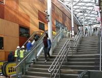 Going up! The one operational 'up' escalator alongside Waverley Steps carries a steady stream of customers from the station up to Princes Street on 8 February 2018. The steps themselves were fully operational in both directions. The shot gives a wide view of the wall of Princes Mall decked out in what appears to have become the official 'Waverley cladding' [see image 62530].<br><br>[John Furnevel 08/02/2018]