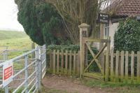 This is the former LC at the end of Gypsy Lane between Wisbech and Ferry on the M&GN line to Sutton Bridge. The view is looking south and the River Nene is out of site behind the banking on the left. The railway was between the banking and the gate. The old wicket gate and the 'Beware of Trains' sign were quite a surprise during the walk along the trackbed on 22 February 2018.<br><br>[John McIntyre 22/02/2018]