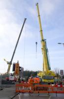 Two impressive cranes, one each side of the railway, working to remove sections of the Muirside Road overbridge as it is cut up <i>in situ</i> at Baillieston station. Unsurprisingly, there is a bus replacement service while the job is in progress. <br><br>[Colin McDonald 11/04/2018]