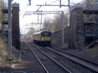 318259 forming the 0839 to Dalmuir approaches Baillieston. [See image 63266] for a very similar photo taken a week earlier with the old road bridge still in place.  <br><br>[Colin McDonald 19/03/2018]