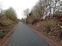 The latest stretch of the Rosslyn Chapel Trail (Glencorse branch, to you and me) takes it through Gilmerton station. Nothing to see at platform level, but the station house is visible through the trees in this view, looking south west. The station was rather isolated when it closed in 1930, but the village had grown southwards since, with the latest housing being built across the road. If only they could have foreseen this 88 years ago ...<br><br>[David Panton 12/03/2018]