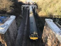 320415 en route to Whifflet passes between the newly capped masonry columns which will support the replacement overbridge at Baillieston station.<br><br>[Colin McDonald 19/03/2018]