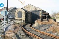 The old goods shed at Shildon in November 2007, now incorporated within the museum grounds with part of the 'Welcome' building visible in the left background. The bus stop alongside on the left is used by the internal bus service provided free to visitors within the museum site. [Ref query 21 March 2018] <br><br>[John Furnevel 04/11/2007]