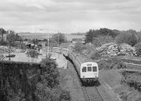 A pair of class 101 units pass the site of Inverkeithing (1st) station with a Navy Day shuttle to Rosyth Dockyard.  The Dunfermline & Queensferry Railway built a station here, replaced by the current one on the opening of the Forth Bridge.<br><br>[Bill Roberton //1985]