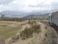 The Furness Fells of the Lake District form a back drop as DRS 68017 accelerates towards Foxfield after the Kirkby-in-Furness stop. The train is a Barrow to Carlisle service on 13th March 2018. <br><br>[Mark Bartlett 13/03/2018]