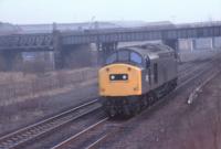 An unidentified Class 40 runs light engine through Whifflet North Junction around 1980. At this time R. B. Tennants were still in full production at the Meadow Works in the to right background. The old Airdrie line to Imperial and Calder is on the left.<br>
<br>
<br><br>[Alastair McLellan //1980]