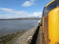 The Leven Viaduct is just as impressive as the Kent Viaduct at Arnside but not quite so accessible for lineside photography. 37402 heads the morning service from Preston to Barrow over the causeway and on to the bridge on 13th March 2018. <br><br>[Mark Bartlett 13/03/2018]