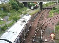 Looking south over Dalmeny Junction on 26 June 2008 as a returning Fife Circle DMU passes below on its way to Edinburgh. The walkway on the left which occupies the trackbed of the old South Queensferry branch has been temporarily closed due to maintenance work taking place on the bridge carrying the A90 in the background. <br><br>[John Furnevel 26/06/2008]