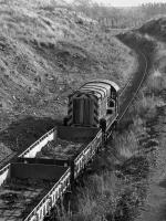 08730 draws empty wagons out of the spent ballast dump, located on the former Up Arrivals part of Millerhill Yard in 1989. In time this would be filled to the level of the surrounding area.<br>
<br><br>[Bill Roberton //1989]