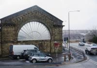 The imposing fan window at Buxton station on 17th March 2018.  The line of the road stands on the site of the forecourt between the LNW and Midland stations.  A matching window adorned the Midland side but was unfortunately demolished upon the station’s closure.  Eagle-eyed observers will have spotted Stanier Class 5 45407 (running as 45157) on the viaduct in the middle distance.  Top and tail with 45690 it had just returned from a very rare foray up the Hindlow Branch with RTC’s High Peak Explorer. <br><br>[Malcolm Chattwood 17/03/2018]