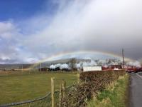 Under a rainbow 37518 leads 44871 and 45407 over Ardmore Level Crossing with the Jacobite stock heaving north from Carnforth to Fort William. <br><br>[Ian Davis 28/03/2018]