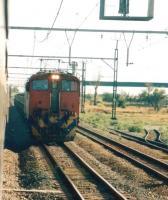 SAR electric locomotive approaching Potchefstroom, around 70 miles south west of Johannesburg, with a freight in November 2005, photographed from a passing train. [Ref query 29 March 2018]<br><br>[Ken Strachan /11/1965]