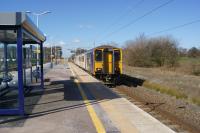 The station at Salwick between Preston and Kirkham has recently been refurbished whilst electrification work was taking place. A brand new waiting shelter has been erected closed in on three sides. One does hope that the icy north wind doesn't blow too often whilst passengers await their train since the shelter has no protection from that direction at all! The train is from Blackpool South to Preston, however like most, it just rushes past and doesn't stop.<br><br>[John McIntyre 19/03/2018]