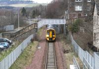 The late running ScotRail 0824 Edinburgh - Tweedbank about to clear Low Buckholmside footbridge on the northern approach to Galashiels station on a grey 22 March 2018. The train is a 5-car 158/170 combination led by 158728 with 170454 bringing up the rear.<br><br>[John Furnevel 22/03/2018]