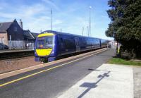 A Dunblane to Edinburgh service pulls into Larbert on 20 March. It is formed of 170 416 sans vinyls, making it look rather bald. It has just passed the now closed Larbert North box (out of shot), looking as if it is still open except that the (rather collectable) name boards have been removed.<br><br>[David Panton 20/03/2018]